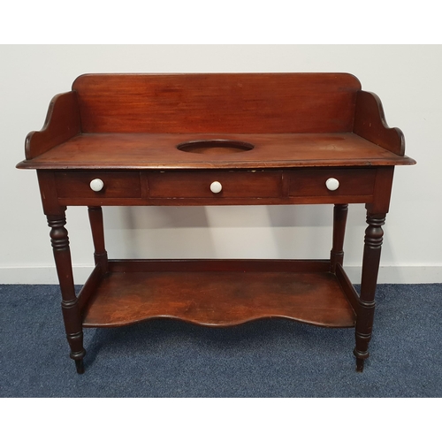 385 - VICTORIAN MAHOGANY WASHSTAND
with a three quarter shaped galleried back and a central circular reces... 