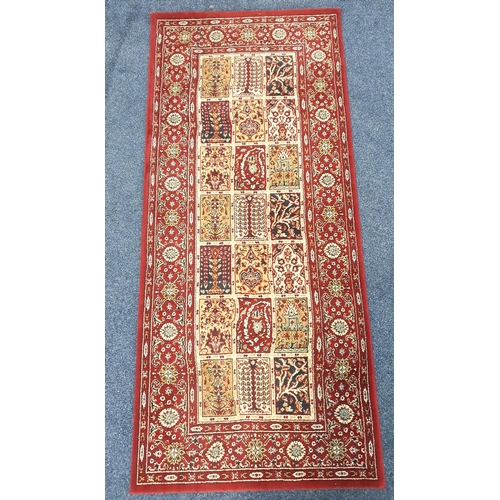 447 - VALBY RUTA RUG
with a deep red ground with floral motifs, 180cm x 80cm