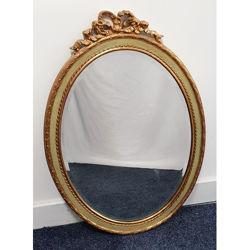 358 - OVAL GILTWOOD MIRROR
surmounted by a bow, with an oval bevelled plate, 71cm high