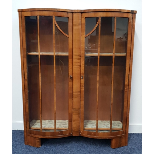 395 - WALNUT BOW FRONT DISPLAY CABINET
with a shaped raised back above a pair of panelled glass doors, 127... 