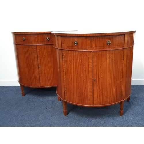 PAIR OF GEORGE III STYLE MAHOGANY AND CROSSBANDED DEMI LUNE SIDE CABINETS
with a central frieze drawer with gilt metal handles above a pair of panelled cupboard doors, standing on stout tapering supports with spade feet, 88.5cm x 94.5cm x 51cm (2)
