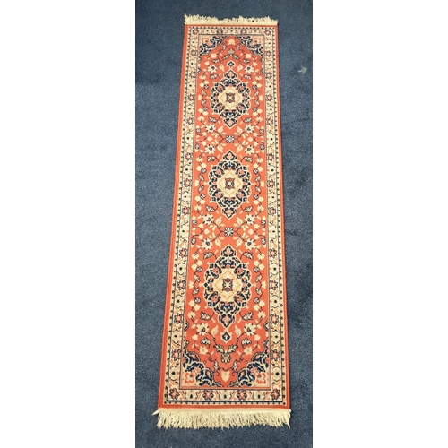 SAROUK RUNNER
with central floral decorated cream ground medallions encased by a brown floral border, 224cm x 59.5cm