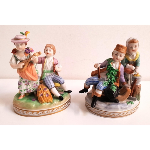 PAIR OF DRESDEN FIGURAL GROUPS
one depicting a winter scene of a boy seated on a sledge and a girl keeping warm by a fire, 12cm high, the other of a boy seated on a log holding a flute, the girl standing playing the mandolin, 13cm high (2)