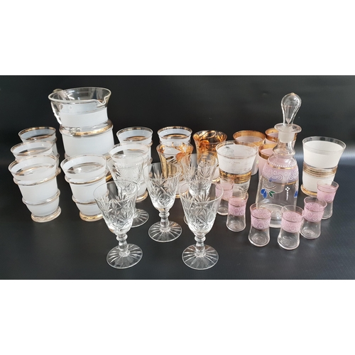 GLASS LEMONADE SET
comprising a jug and seven glasses with frosted decoration and gilt highlights, continental spirit decanter and six shot glasses and other assorted glasses