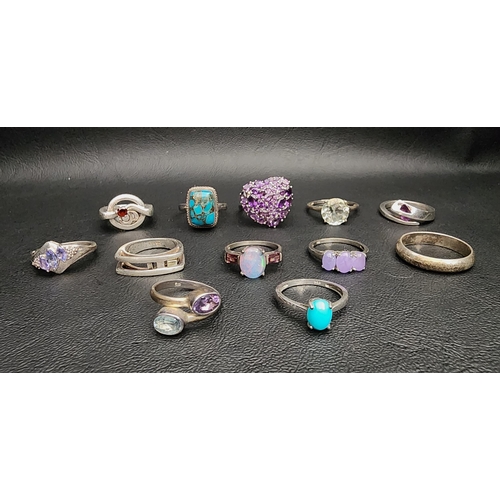 SELECTION OF TWELVE SILVER RINGS
including a shaped Malcolm Gray example, an amethyst and blue topaz twist ring, and others set with turquoise, opal triplet, garnet, etc. (12)