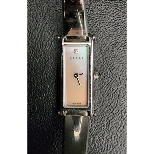 71 - LADIES GUCCI WRISTWATCH 
the rectangular mother-of-pearl dial with a clear stone at 12, in stainless... 