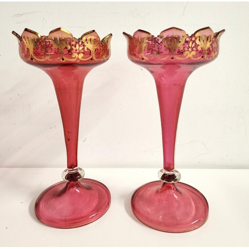 202 - PAIR OF EDWARDIAN CRANBERRY GLASS SPILL VASES
of trumpet form with gilt highlights on circular bases... 