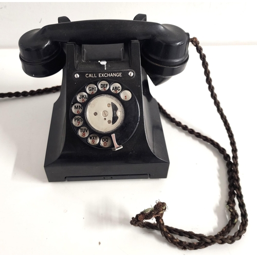 VINTAGE BAKELITE TELEPHONE
with a one piece handset with original plaited cord, circular dial with an alpha numeric dial plate above a pull out drawer and numbered to the underside L.11568.B1