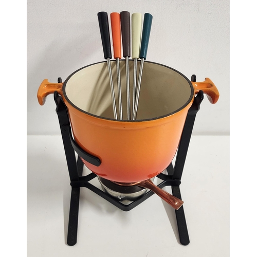 LE CRUESET FONDUE SET
in enamelled orange with a burner and cover, stand and five long forks with coloured handles