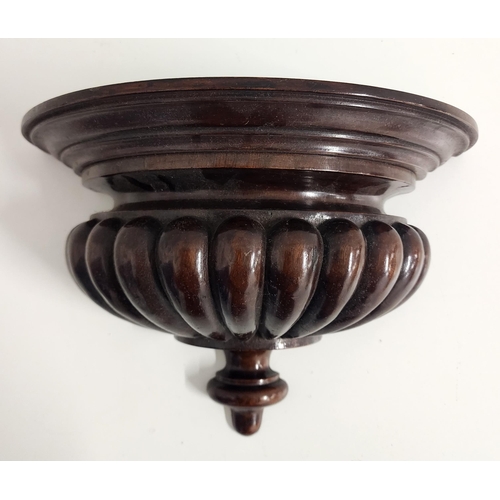 275 - MAHOGANY WALL BRACKET
with a moulded semi elliptical top above a lobed body, 22cm x 33cm