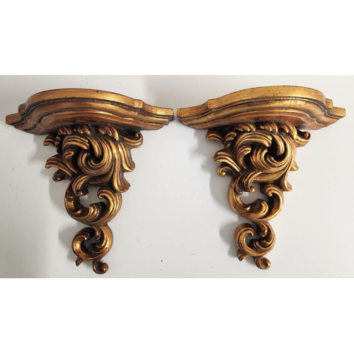 278 - PAIR OF GILTWOOD WALL BRACKETS
with shaped tops above entwined scrolls, 28cm x 30cm (2)