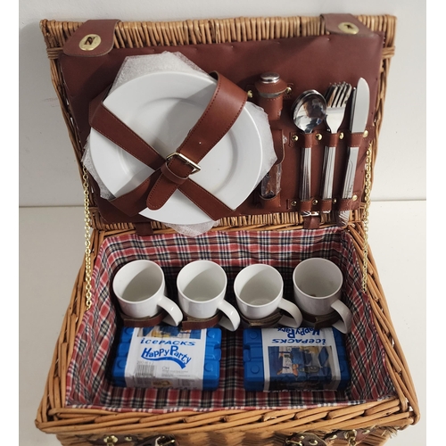 WICKER PICNIC BASKET
with closure straps and carry handle, the fitted interior for four people including plates, knives, forks, spoons, cups, pepper pot, corkscrew and two ice packs, 21cm x 40cm x 29cm