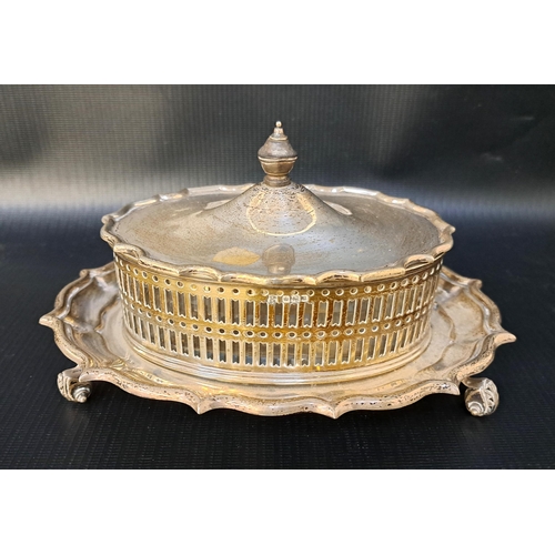 167 - GEORGE V SILVER BUTTER DISH
of oval form with a shaped lid above a pierced oval body with a glass li...