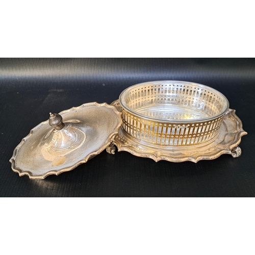 167 - GEORGE V SILVER BUTTER DISH
of oval form with a shaped lid above a pierced oval body with a glass li... 