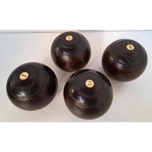 SET OF FOUR VINTAGE LAWN BOWLS
in lignum vitae by R.G. Lawrie of Glasgow, with inset disks inscribed D.G.H. (4)