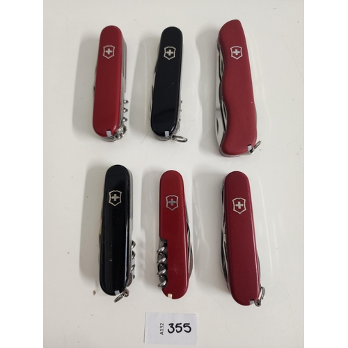 SIX VICTORINOX SWISS ARMY KNIVES
of various sizes and designs 
Note: You must be over the age of 18 to bid on this lot.