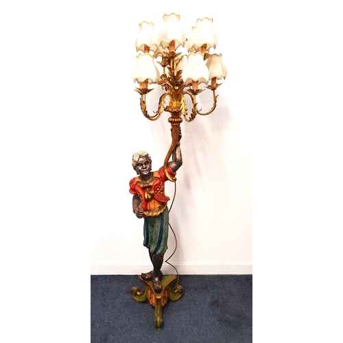 437 - BLACKAMORE FIGURAL LAMP
the carved wood figure raised on a tripod base brightly painted holding a te... 