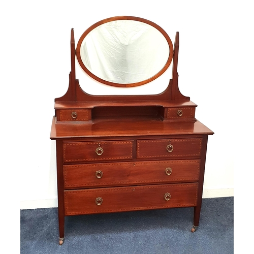 EDWARDIAN MAHOGANY AND INLAID DRESSING CHEST
with an oval bevelled mirror above two jewellery drawers with two short and two long drawers below, standing on tapering supports with porcelain casters, 160cm x 115cm x 53cm
Note: See lot 468 and 470 for matching lots