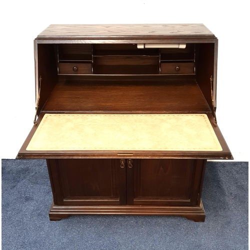 471 - OAK BUREAU
with a carved panel fall flap opening to reveal a fitted interior above a long drawer wit... 