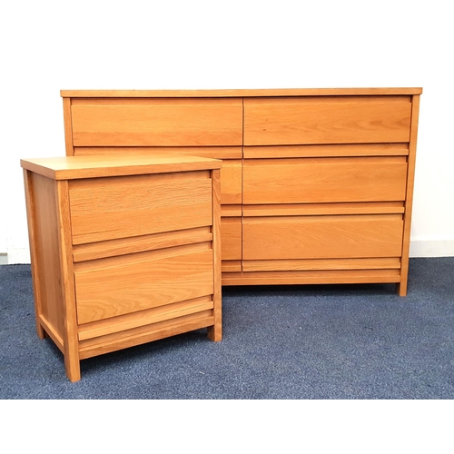 OAK FURNITURE LAND LARGE CHEST OF DRAWERS
in light oak with a rectangular top above three pairs of drawers, 82cm x 132.5cm x 46cm, together with a matching light oak bedside chest with two drawers, 59cm x 50.5cm x 39.5cm (2)