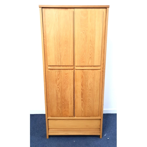 476 - OAK FURNITURE LAND WARDROBE
in light oak with a pair of panelled doors opening to reveal a hanging r... 