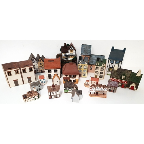 322 - SELECTION OF POTTERY AND RESIN HOUSES
some modelled as cottages, churches and shops, with seven exam... 