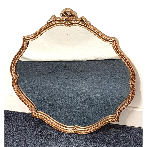 439 - SHAPED WALL MIRROR
with a plain plate, the frame surmounted by a bow, 54cm x 50cm