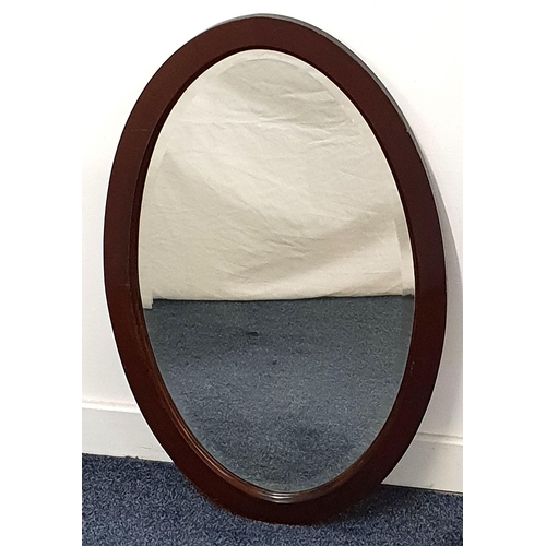 441 - MAHOGANY OVAL WALL MIRROR
with a bevelled plate, 77cm x 49.5cm