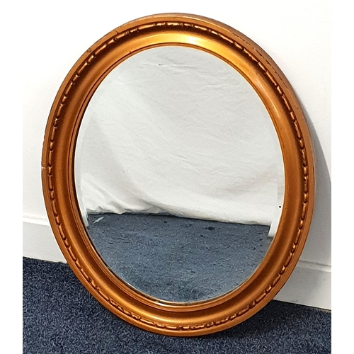 446 - GILT FRAME OVAL WALL MIRROR
with a bevelled plate, 60cm x 50cm