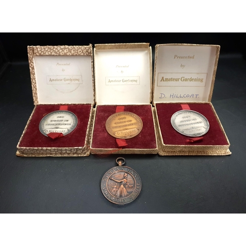 384 - THREE BOXED GARDENING MEDALS
awarded to D.Hillcoat 'For Merit In Horticulture' and a 'Woman's Own Co... 