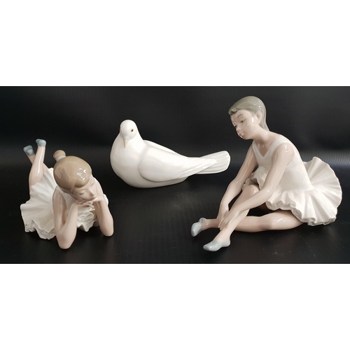 227 - THREE NAO FIGURINES
comprising a seated ballerina adjusting her shoe, 14cm high, a ballerina lying d... 