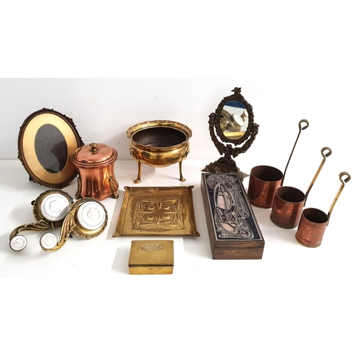 SELECTION OF METALWARE
comprising a copper tea caddy and caddy spoon marked 'DP', brass stamp box, two brass and enamel servants bells, brass Arts and Crafts embossed dish decorated with dragonfly, an Arts and Crafts style enamel and pewter box, three graduated brass and copper Rum measures, oval photograph frame, small brass oval mirror and a circular brass planter