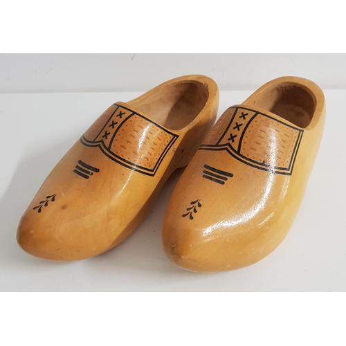 317 - PAIR OF CARVED WOODEN CLOGS
with applied decoration