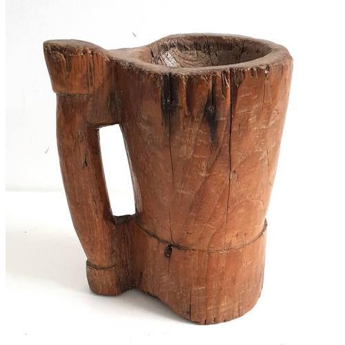 EARLY 18th CENTURY ELM MORTAR
of cylindrical form with a side handle, 22cm high