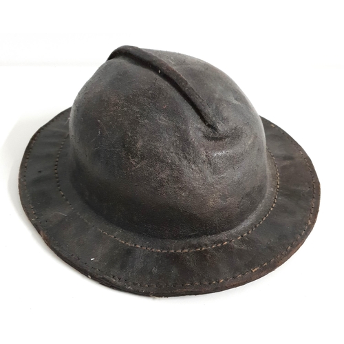 18th CENTURY LEATHER MINERS HELMET
possibly Belgian, with a double stitched brim