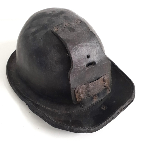 341 - 20th CENTURY CHILDS LEATHER MINERS HELMET
with impressed '56' to the brim and leather flap for lamp ... 