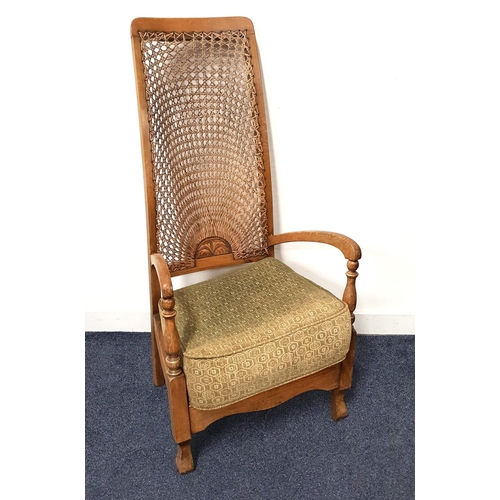 478 - 1950s OAK ARMCHAIR
with a shaped caned back above outswept arms and a loose seat cushion, on turned ... 