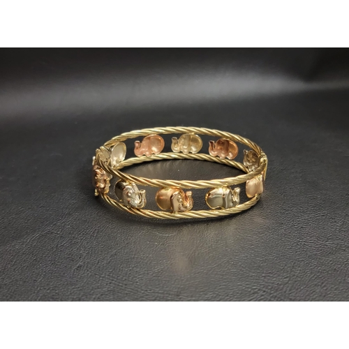 EIGHTEEN CARAT TWO TONE GOLD ELEPHANT DECORATED BANGLE
with a row of alternating brushed rose gold and polished yellow gold elephants with rope twist bands above and below, by Graziella, approximately 19.7 grams