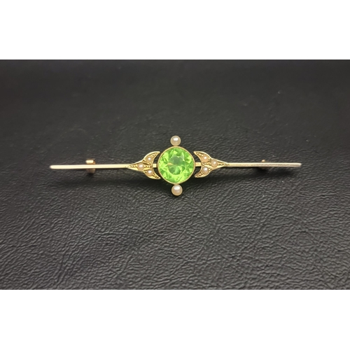 EARLY 20th CENTURY GEM SET FIFTEEN CARAT GOLD BAR BROOCH
the central round cut green gemstone probably demantoid garnet approximately 3cts, in seed pearl surround, 6.5cm long and approximately 5.1 grams