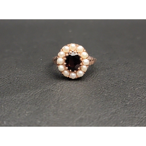 GARNET AND PEARL CLUSTER RING
the central oval cut garnet approximately 1ct in twelve pearl surround, on nine carat rose gold shank, ring size O