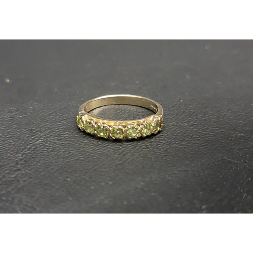 PRETTY PERIDOT HALF ETERNITY BAND RING
with seven round cut peridots, on a nine carat gold shank, ring size P