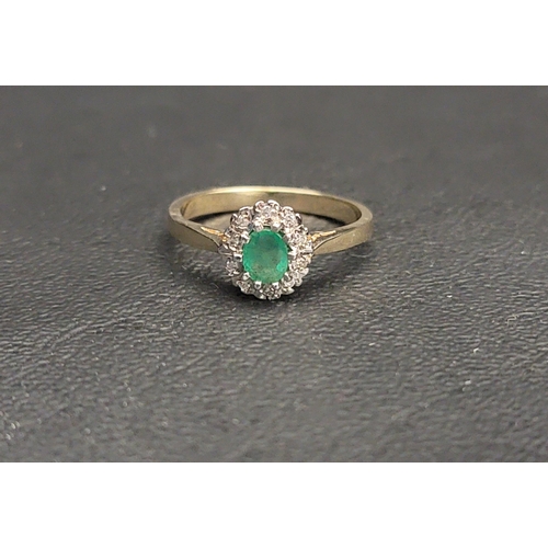 86 - PRETTY EMERALD AND DIAMOND CLUSTER RING 
the central oval cut emerald measuring approximately 0.2cts... 