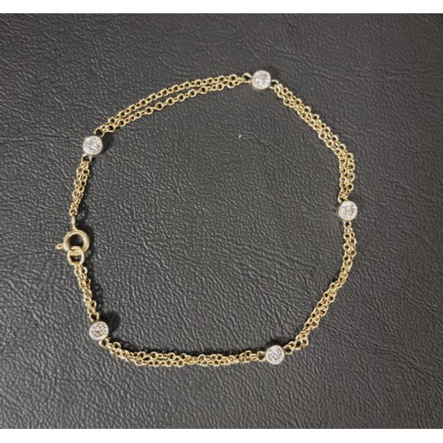 PRETTY NINE CARAT GOLD DIAMOND SET BRACELET
the two belcher chains joined periodically by five bezel set diamonds, measuring approximately 0.15cts each, total weight approximately 3.1 grams and 20cm long