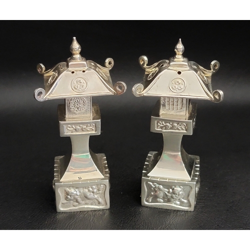 184 - STERLING SILVER PAGODA SALT AND PEPPER SHAKERS
both with embossed decoration, 7.3cm high and total w... 