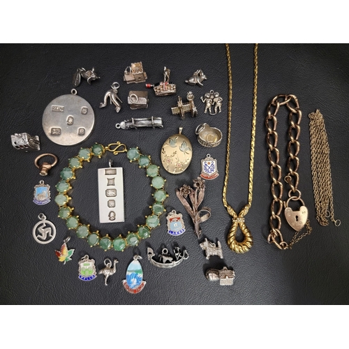 SELECTION OF SILVER AND OTHER JEWELLERY
including two silver ingot pendants, one rectangular and the other circular (total weight 45.7 grams); a selection of mostly silver charms including an articulated shoe, church and cottage; a jade coloured hardstone bracelet; a gold plated locket pendant, etc.