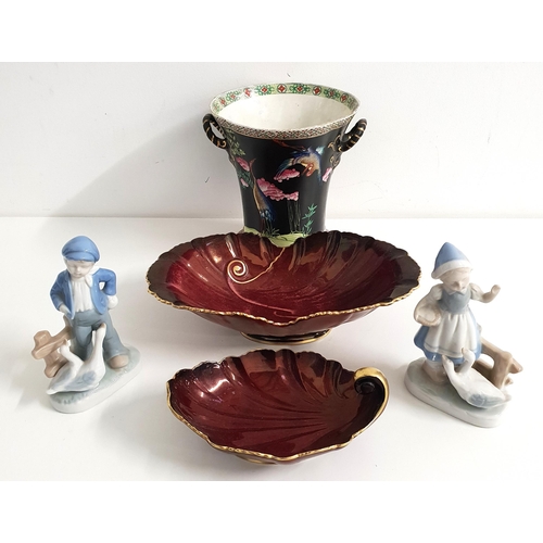 MIXED LOT OF CERAMICS
comprising two Carlton Ware Rouge Royale shaped dishes, both with gilt highlights, 18cm long; two continental figurines of a boy with geese and a girl with geese, both 15cm high; and a famille noir vase of tapering form, decorated with cranes and with side handles, 19cm high (5)