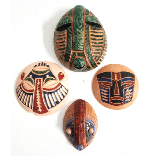 FOUR TERRACOTTA MINATURE AFRICAN MASKS
one with a green glaze marked Batantuy 6/2/20 to verso, 12.5cm high, a round mask with blue, red and green glaze marked Vikikek to verso, 10cm diameter, a round mask with blue, red and black glaze marked Kiketri Art Zaire to verso, 8.4cm diameter, and an oval mask with red, green and blue glaze indistinctly marked to verso, 8.7cm high (4)