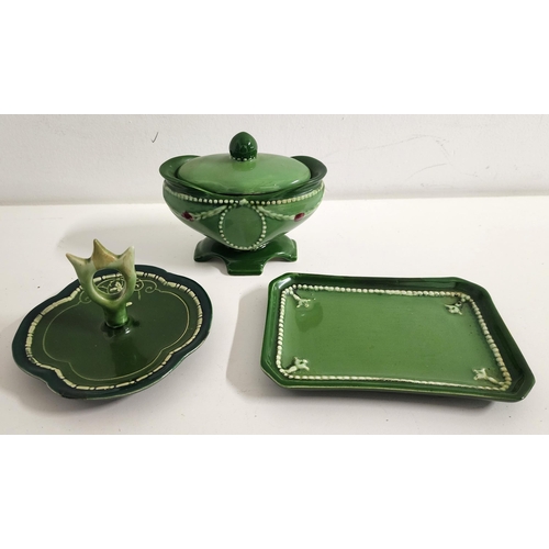 SELECTION OF EICHWALD POTTERY
comprising a pin dish of rectangular form, the base impressed 2502, 13cm long; a trinket dish decorated with a rose; and an oval lidded bowl decorated with swags and flowers, all with a green glaze (3)