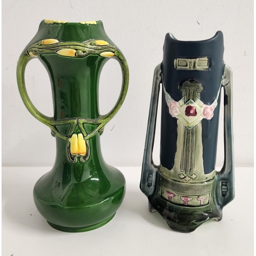 TWO EICHWALD POTTERY VASES
each with a green ground and twin handles with tapering bodies, the bases impressed 741 Austria, 19.5cm high and 5975, 18cm high (2)