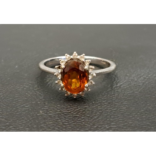 CITRINE AND CLEAR GEM SET CLUSTER RING
the central dark oval cut citrine approximately 1ct in clear gem set surround, on ten carat white gold shank, ring size N and approximately 2.6 grams